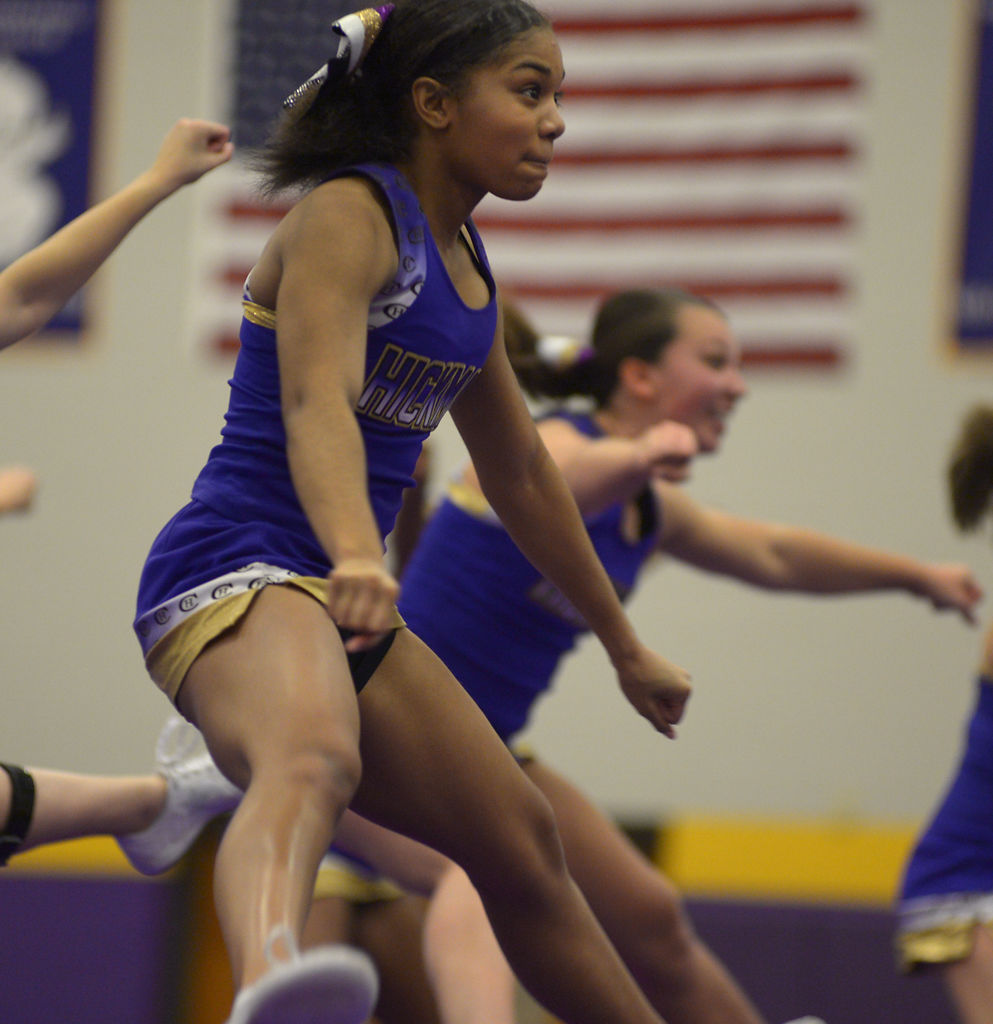 Aniya Crum jumps with the rest of the Hickman cheer